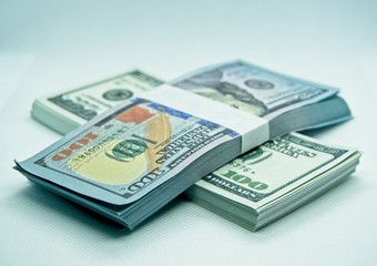 wad of 100 dollar bills in a white background