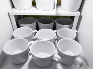 lots of white cups. Top view on many stacked in rows of empty clean white cups for tea or coffee
