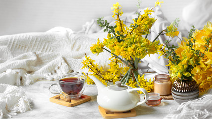 Spring still life with a Cup of tea and flowers .