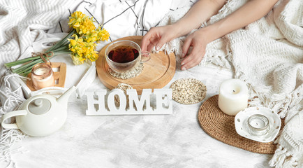 Spring still life with a Cup of tea and flowers .
