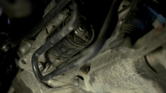 Mechanic repairman uninstalling car cylinder. Close up hands of a car service worker.