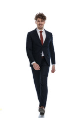 Happy businessman smiling and walking forward