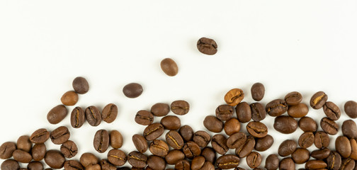 Scattered coffee beans on a white background