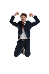 Happy businessman celebrating with both hand in the air
