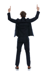 Rear view businessman pointing up with both of his hands