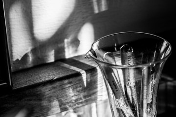 Glass ampoules containing silk sutures from the 1950s in a graduated cup. It is a way of containing...