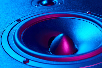 Sound audio speaker with neon lights. Dynamic monitor close up. Creative backgroound