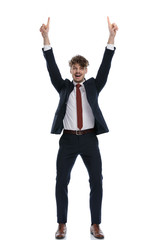 Happy businessman pointing up with both hands and laughing