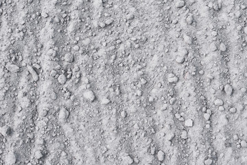 Dry soil background. Sand with stones as a texture