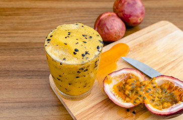 Passion fruit smoothie in a glass on wood table and nature background, Refreshing to thirsty drink in summer, Good food high vitamin C, Nourishing the eyes, Relieve constipation. Rich in antioxidants.