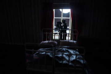 Beautiful passionate young couple lying on bed and having sex. Sensual man and woman making love in bedroom.