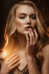 Close up portrait of beautiful blonde woman with natural colors makeup, luxury long waved hair