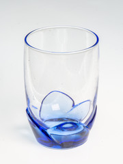 Transparent blue glass with flower-style base