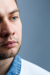 Closeup portrait of a man in a white polo on a white background. Male image for every day. Stylish guy