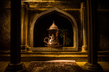 Arabian tea in glass inside room. Low light lounge interior with carpet. Selective focus