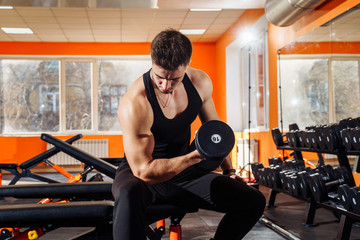 Portrait of athletic, handsome, young, muscular european brunette doing physical exercises, biceps...