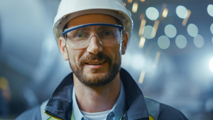 Portrait of Professional Heavy Industry Engineer / Worker Wearing Safety Uniform, Goggles and Hard...