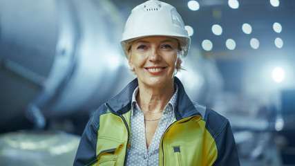 Portrait of Professional Heavy Industry Female Engineer Wearing Safety Uniform and Hard Hat,...