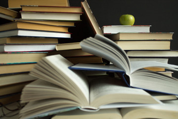 Clutter on the table - a lot of open and closed books close-up © Inna