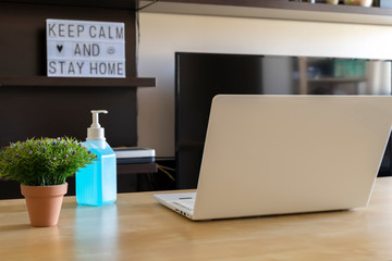 Photography of a home office with a laptop on the desk an a lightbox in the background.