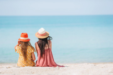 Beautiful mother and daughter on the beach