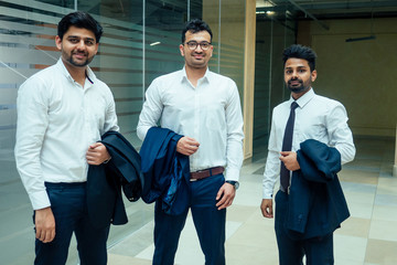 well-dressed business indian men making a report to subordinate employees in a modern office