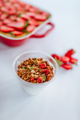 Strawberry cake and granola yogurt with red berry jam on the white backgound