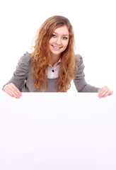 Naklejka premium woman holding sign - Portrait of a beautiful woman holding a blank billboard.