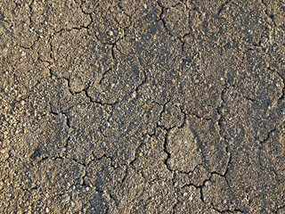 Cracked dry ground mud, dried under sun road.