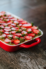 Strawberry cake on the old dark wooden table 