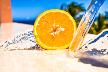 beautiful half orange with water under a blue sky