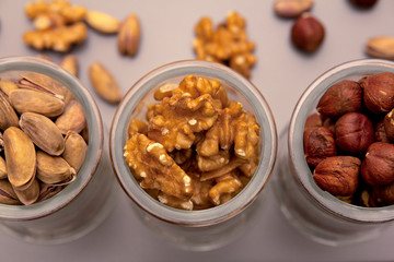 hazelnut, walnut and pistachio nut. mixed assorted nuts in glass box on light background