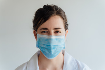 Covid19, coronavirus, healthcare and doctors concept. Portrait female doctor in medical mask and white coat, look after patients checking lungs, consulting how prevent caught virus