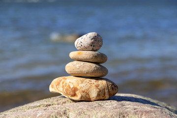 Fototapeta na wymiar Concept of harmony and balance. Rock zen on a background of a summer beach.