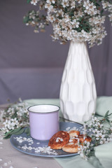 Breakfast in the morning, toasted beautiful cheesecakes on a plate on the tablecloth next to a spring bouquet of flowers