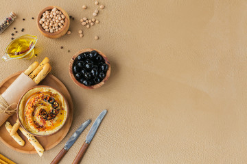 Healthy breakfast with homemade hummus, black olives and crispbread.