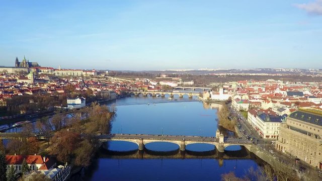 Prague skyline aerial view from adobe fly over river and bridge old town.