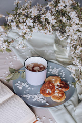 spring healthy Breakfast fried cheesecakes, against a blooming bouquet flowers