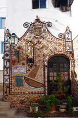 facade and entrance of building decorated with shell mosaic