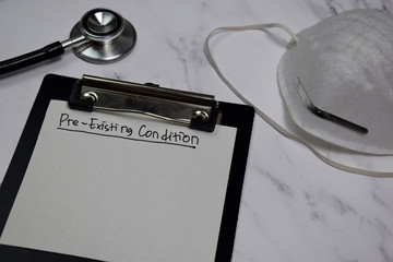 Pre-Existing Condition write on clipboard isolated on office desk