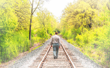 A person is walking along a abandoned railroad 