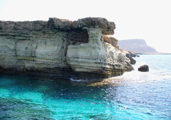 Fototapeta na wymiar Cave in the mountain on the blue sea.Cape Greco and the blue lagoon