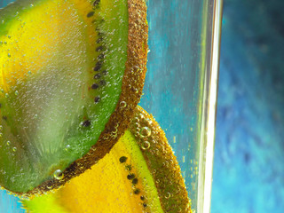slices of kiwi fruit in sparkling water. beautiful macro photography of fruit