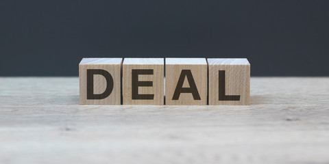 DEAL word on cube blocks on wooden background