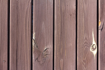 The background is made of wooden boards. The texture of an rustic wooden fence