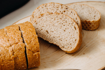 sliced whole wheat bread with knife on wooden drops