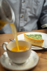 A man pours himself a tea drink.