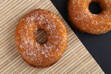 Polish donut,traditional sweet donuts on black background. Delicious, but unhealthy food on the old wooden table with copy space