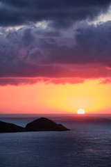 Naklejka na ściany i meble Sea sunset. Seascape sunset with island. Sun setting down in sea. Crete island, Greece