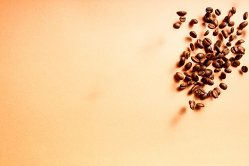 Roasted coffee beans in flight on a cream colored background